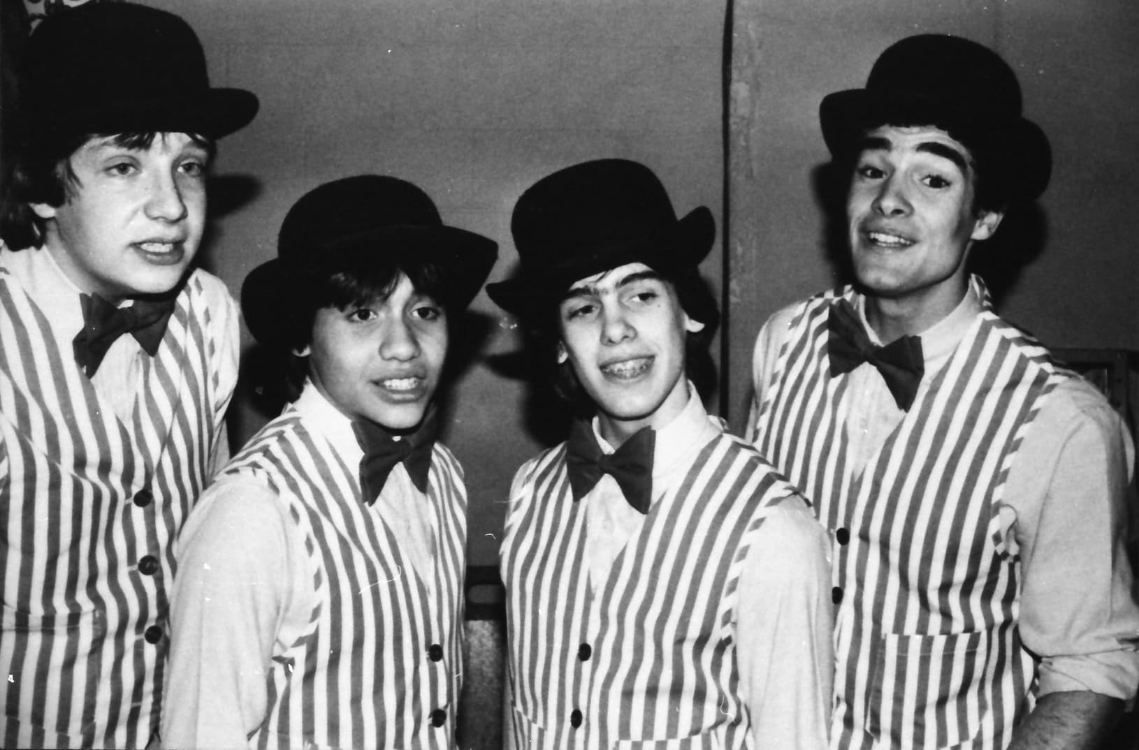 A young barbershop quartet in striped vests and boater hats, 1987.